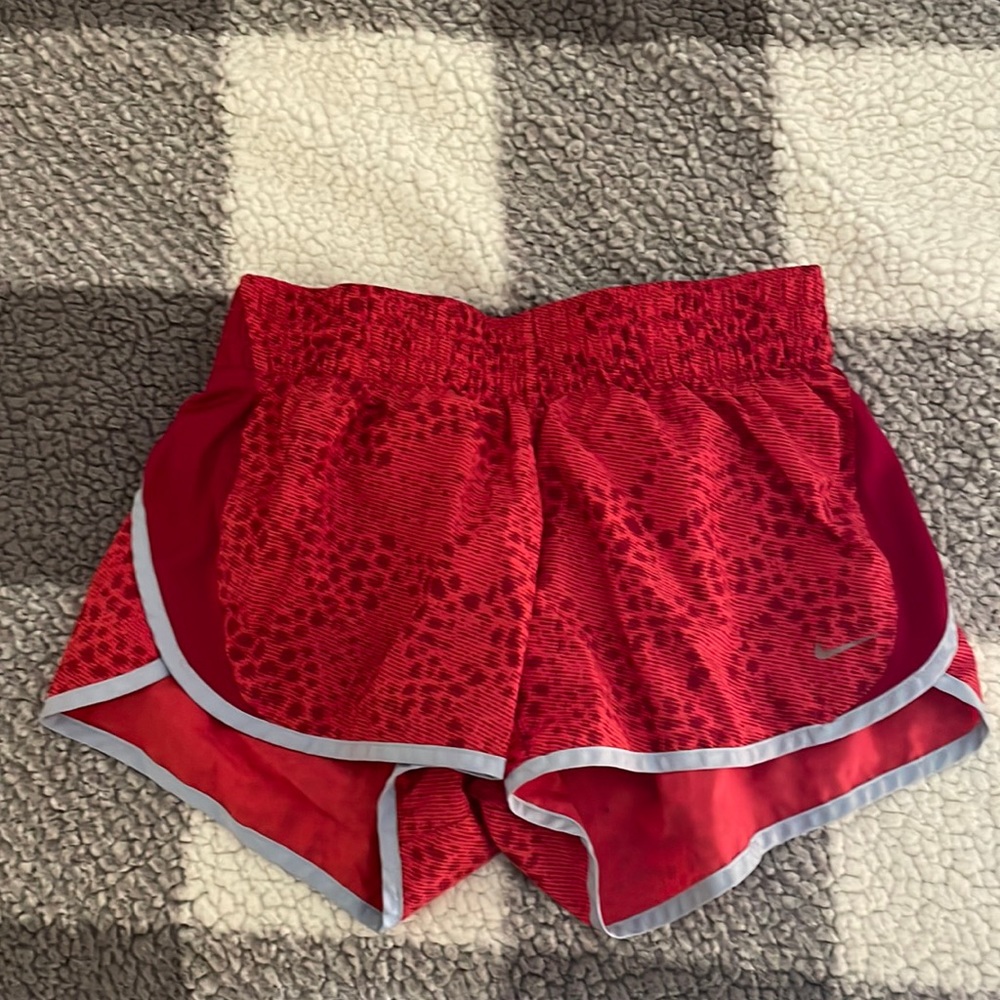 Red Nike running shorts.